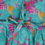 Aqua blue sleeveless frock for girls aged 1 to 4 years, made of slub cotton with colorful tropical bird and leaf print – from Boon Babies, Coimbatore.