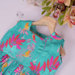 Aqua blue sleeveless frock for girls aged 1 to 4 years, made of slub cotton with colorful tropical bird and leaf print – from Boon Babies, Coimbatore.