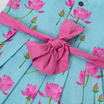 Adorable sleeveless cotton frock with pink lotus prints & bow. Ages 1–4 years. Comfortable, stylish & perfect for festive and casual occasions.