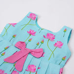 Adorable sleeveless cotton frock with pink lotus prints & bow. Ages 1–4 years. Comfortable, stylish & perfect for festive and casual occasions.