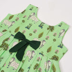 Cute sleeveless cotton frock in green with deer & floral prints. Ages 1–4 years. Soft, breathable & perfect for festive and casual looks.