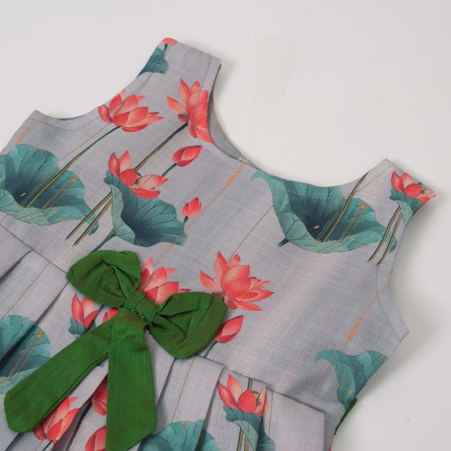 Cute cotton sleeveless frock with lotus print & bow. Perfect for ages 1–4 years. Stylish, breathable & comfy for everyday and festive wear.