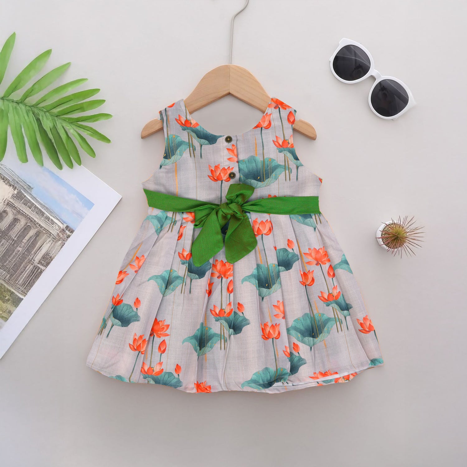 Cute cotton sleeveless frock with lotus print & bow. Perfect for ages 1–4 years. Stylish, breathable & comfy for everyday and festive wear.