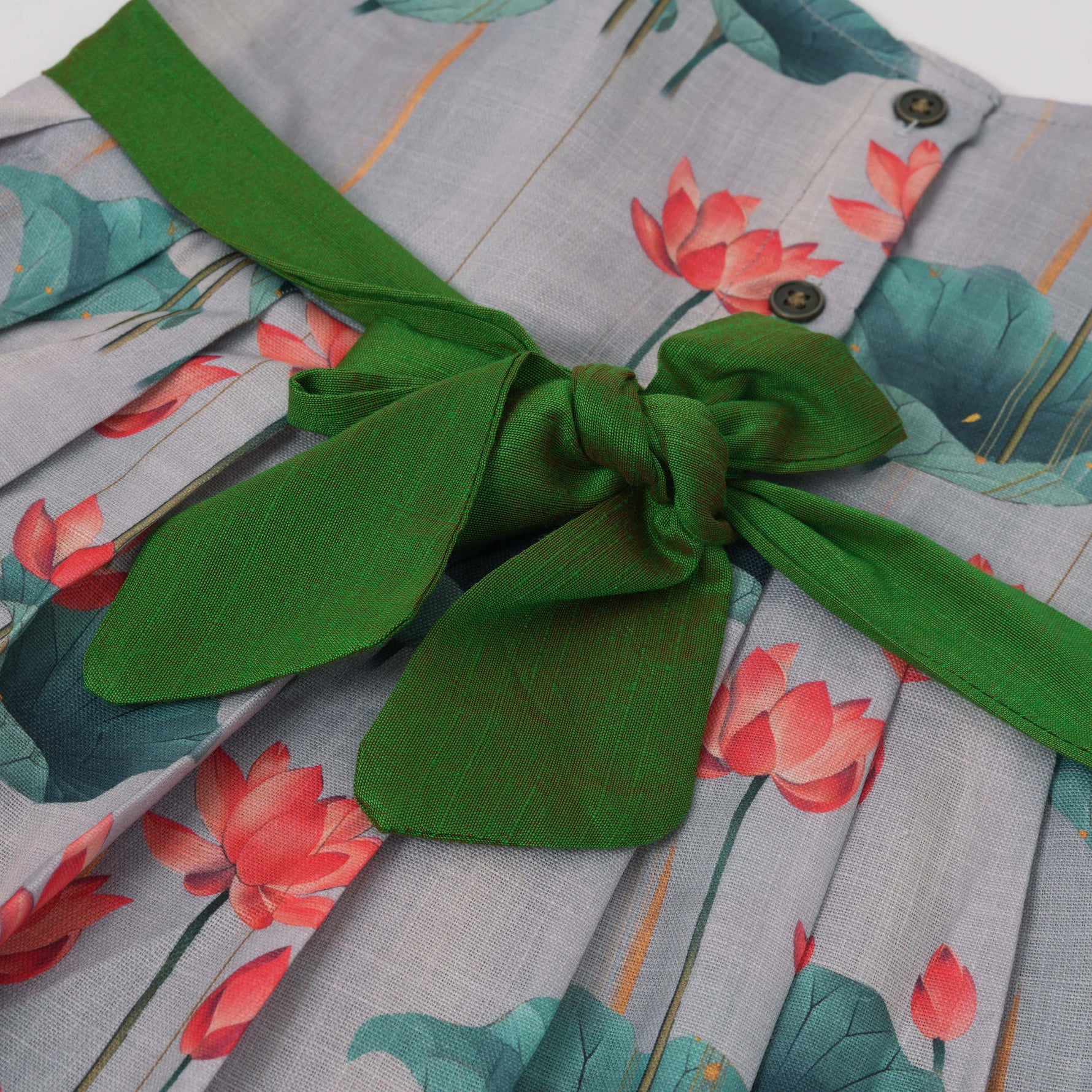 Cute cotton sleeveless frock with lotus print & bow. Perfect for ages 1–4 years. Stylish, breathable & comfy for everyday and festive wear.