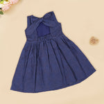Navy blue sleeveless Hakoba frock for baby girls, featuring soft floral embroidery and pleated cotton design, placed flat on a beige backdrop with heart-shaped decor.
