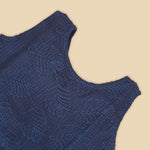 Navy blue sleeveless Hakoba frock for baby girls, featuring soft floral embroidery and pleated cotton design, placed flat on a beige backdrop with heart-shaped decor.