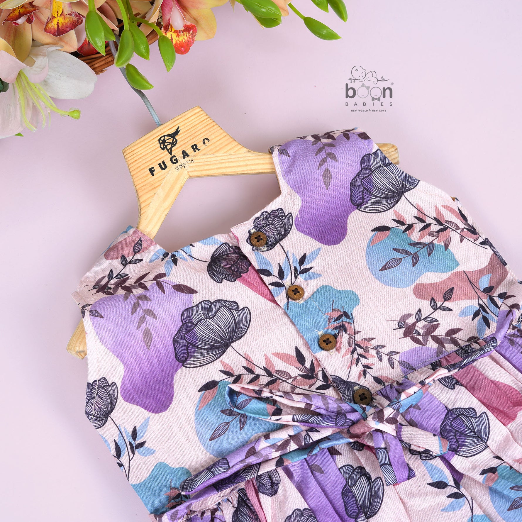 Sleeveless frock for girls aged 1 to 4 years in slub cotton, featuring abstract floral pastel print in lavender, pink, blue, and beige – from Boon Babies, Coimbatore.