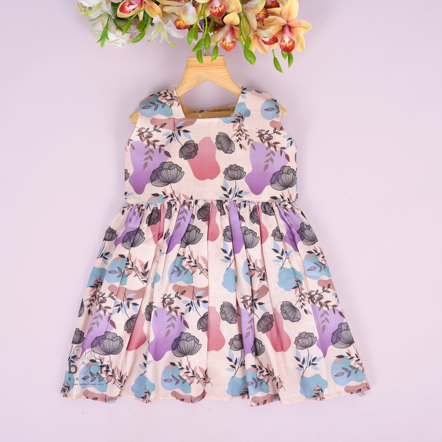 Sleeveless frock for girls aged 1 to 4 years in slub cotton, featuring abstract floral pastel print in lavender, pink, blue, and beige – from Boon Babies, Coimbatore.
