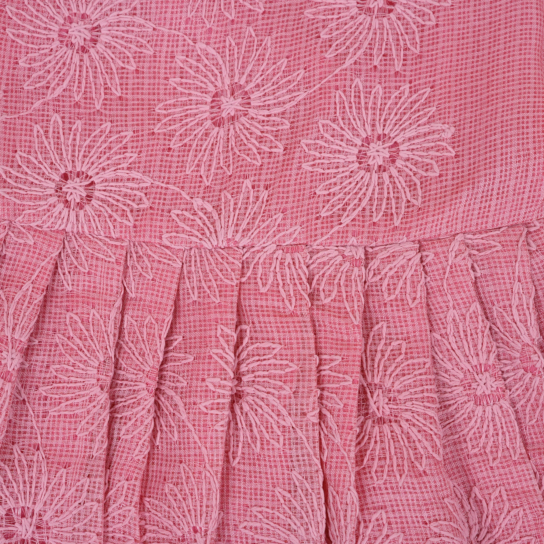 Pink sleeveless Hakoba frock for baby girls, featuring floral embroidery and pleated skirt design, laid flat on a beige background with soft floral props.