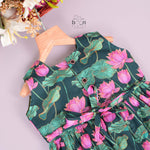 Sleeveless dark green frock for girls aged 1 to 4 years, featuring pink lotus floral print in slub cotton – from Boon Babies, Coimbatore.