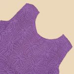 Orchid purple Hakoba frock for baby girls, sleeveless with floral embroidery and pleated skirt, displayed flat on beige background with soft props.