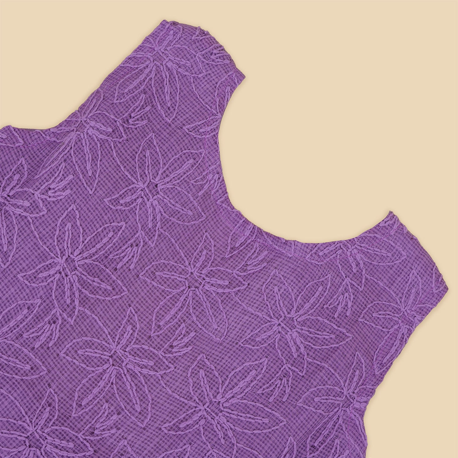 Orchid purple Hakoba frock for baby girls, sleeveless with floral embroidery and pleated skirt, displayed flat on beige background with soft props.