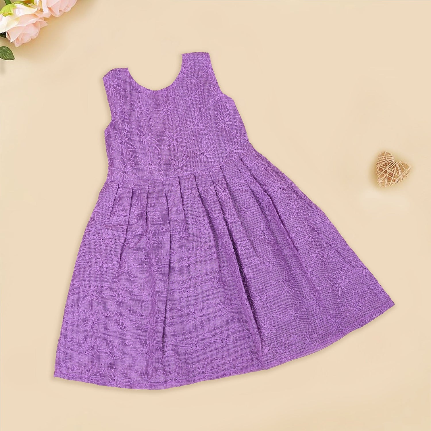 Orchid purple Hakoba frock for baby girls, sleeveless with floral embroidery and pleated skirt, displayed flat on beige background with soft props.