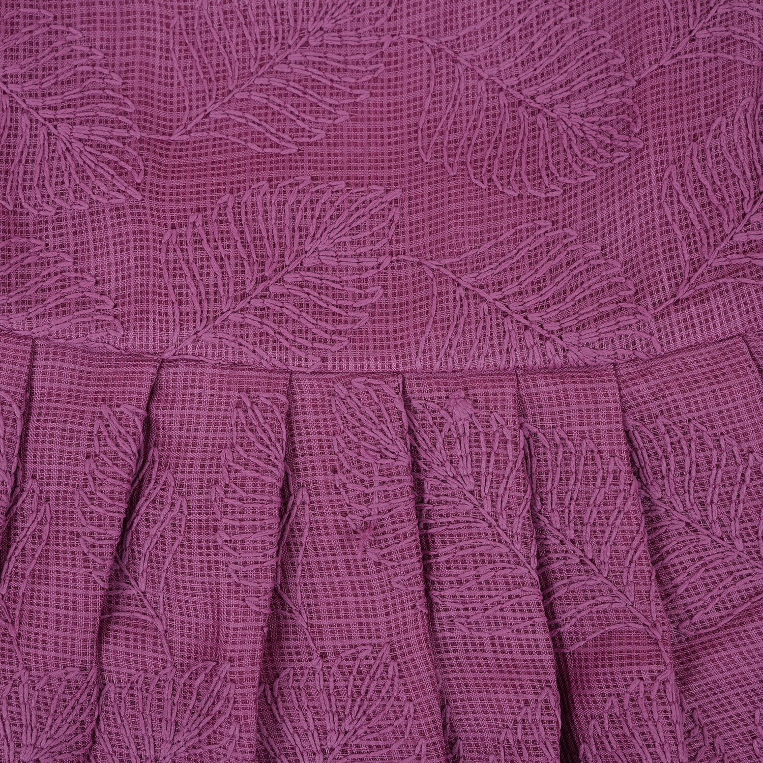 Wine-colored Hakoba frock for baby girls with sleeveless cut, floral embroidery, and pleated skirt design, laid flat on a beige background with floral props.