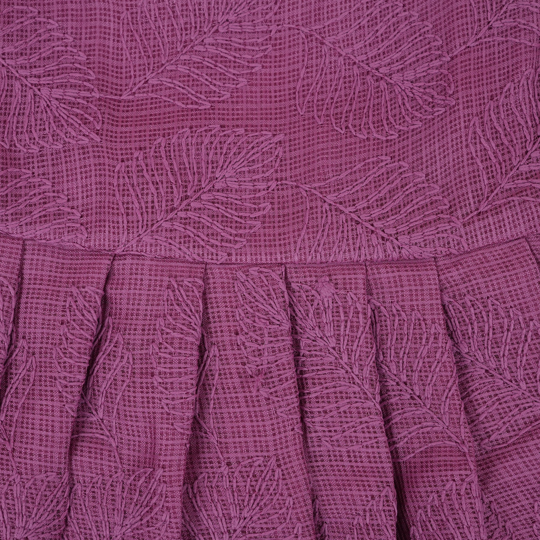 Wine-colored Hakoba frock for baby girls with sleeveless cut, floral embroidery, and pleated skirt design, laid flat on a beige background with floral props.