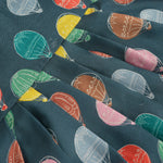 Little girl in a sleeveless denim blue frock with colorful balloon prints, made of slub cotton – part of Boon Babies babywear collection in Coimbatore.