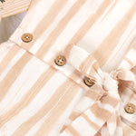 Smiling young girl wearing a sleeveless beige and white striped cotton frock from Boon Babies’ kidswear collection in Coimbatore – perfect for ages 6 months to 5 years.