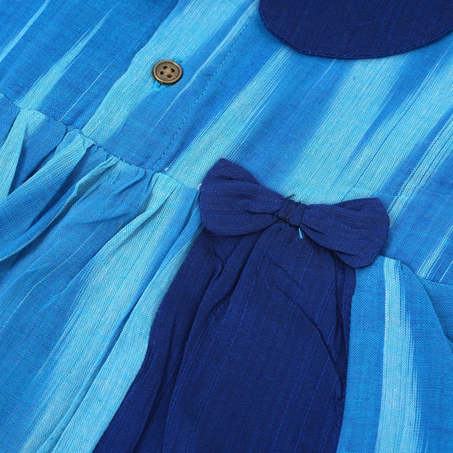 Blue cotton puff frock with navy collar & bow. Sizes 6M–4Y. Stylish, comfy & perfect for festive or casual wear.