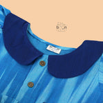 Blue cotton puff frock with navy collar & bow. Sizes 6M–4Y. Stylish, comfy & perfect for festive or casual wear.