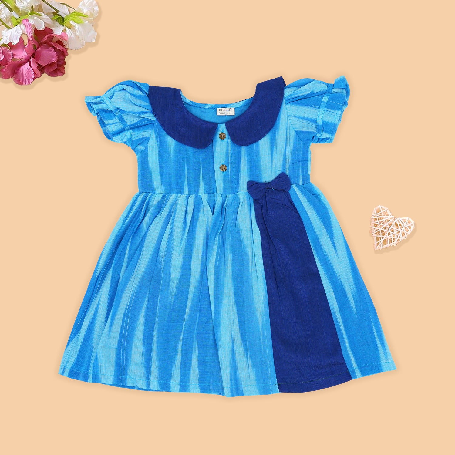 Blue cotton puff frock with navy collar & bow. Sizes 6M–4Y. Stylish, comfy & perfect for festive or casual wear.