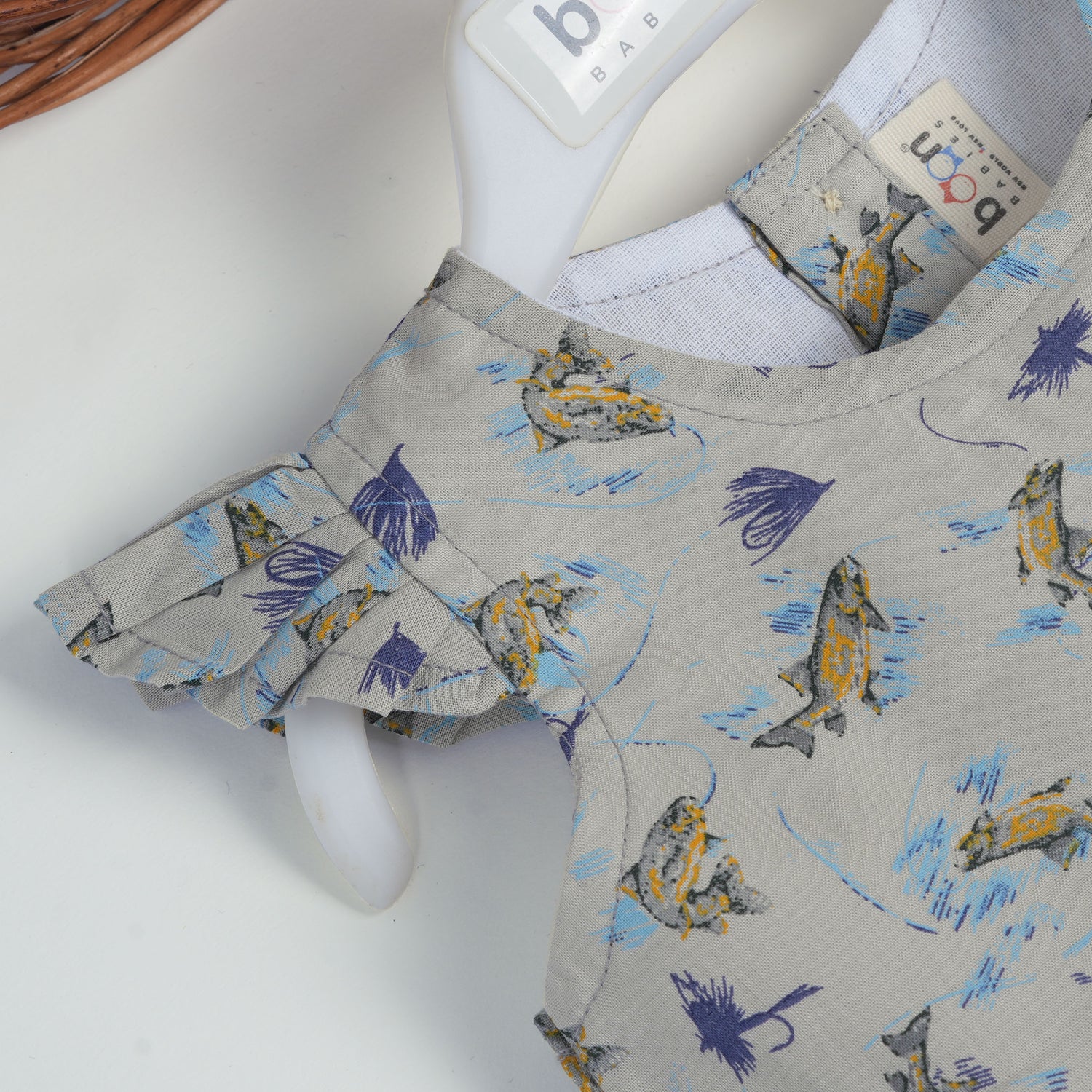 Blue floral cotton frock for girls with ruffle cap sleeves, designed for 6 months to 5 years – from Boon Babies kidswear collection, Coimbatore.
