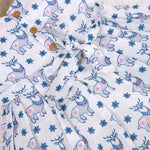 Baby girl wearing a white sleeveless frock with blue reindeer prints, made from slub cotton – part of the Boon Babies kidswear collection in Coimbatore.