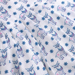 Baby girl wearing a white sleeveless frock with blue reindeer prints, made from slub cotton – part of the Boon Babies kidswear collection in Coimbatore.