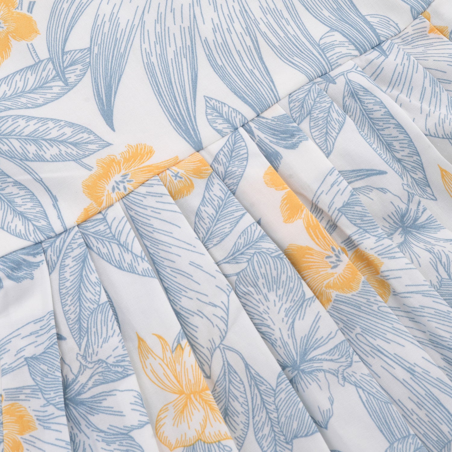 White cotton frock with soft floral prints in blue & yellow. Comfy cap sleeves, perfect for 6M to 5Y girls.