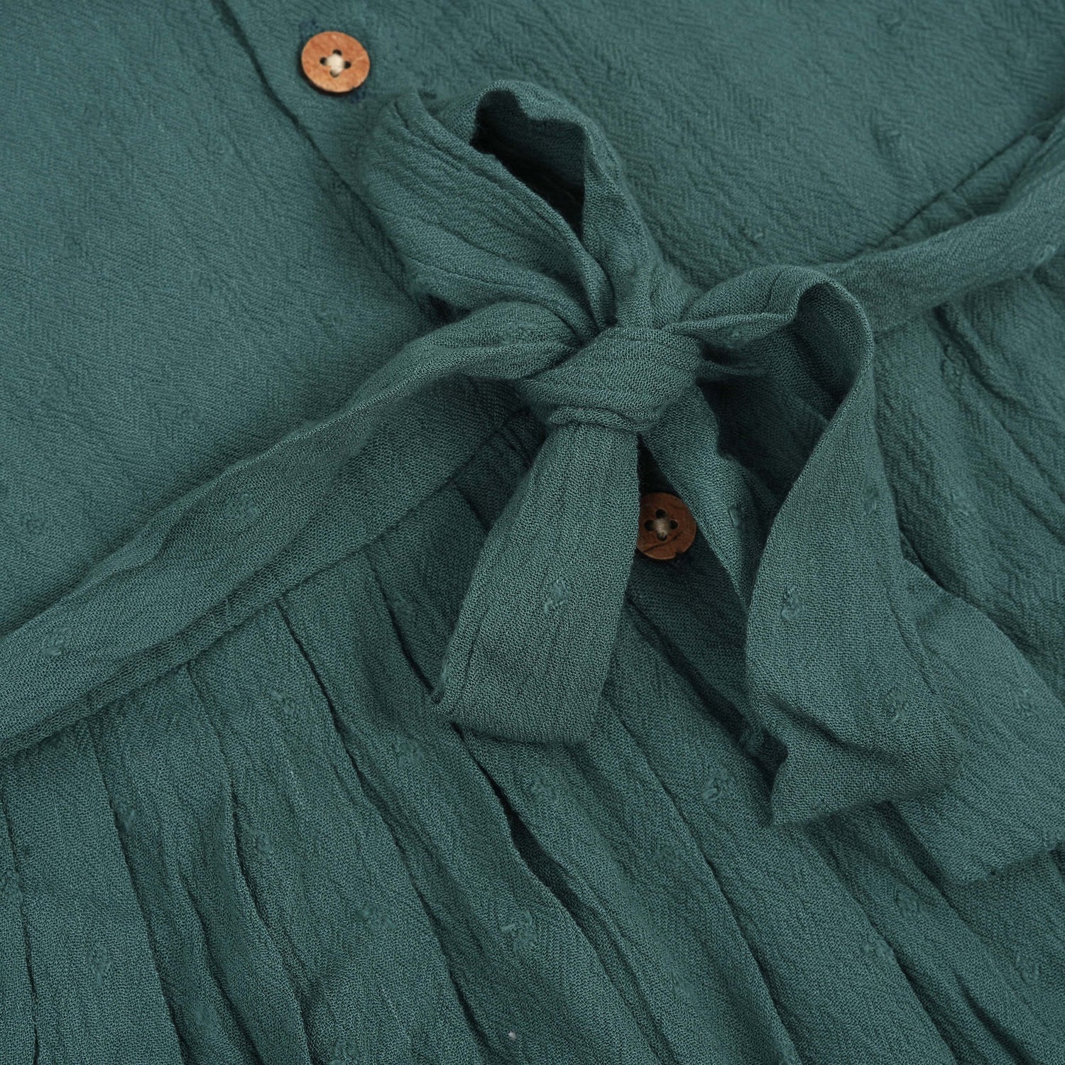 Minimalist bottle green frock in soft cotton. Cap sleeves. Sizes 6M to 5Y. Perfect for play or outings.
