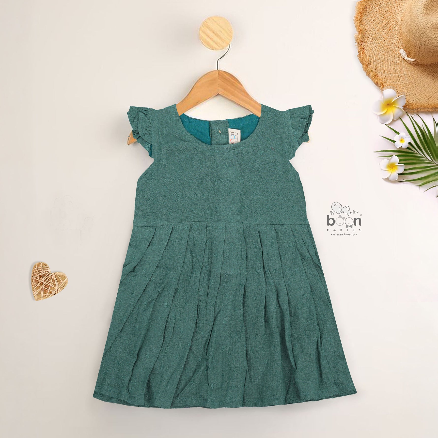 Minimalist bottle green frock in soft cotton. Cap sleeves. Sizes 6M to 5Y. Perfect for play or outings.
