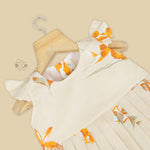Elegant cream floral frock with flutter sleeves, made from breathable cotton. Available for 6 months to 5 years. A perfect daily wear from Boon Babies.
