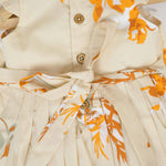 Elegant cream floral frock with flutter sleeves, made from breathable cotton. Available for 6 months to 5 years. A perfect daily wear from Boon Babies.
