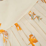 Elegant cream floral frock with flutter sleeves, made from breathable cotton. Available for 6 months to 5 years. A perfect daily wear from Boon Babies.
