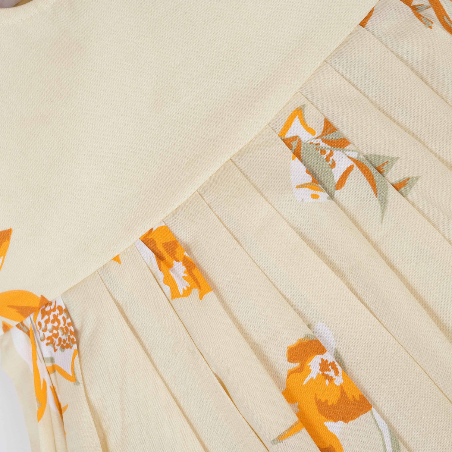 Elegant cream floral frock with flutter sleeves, made from breathable cotton. Available for 6 months to 5 years. A perfect daily wear from Boon Babies.
