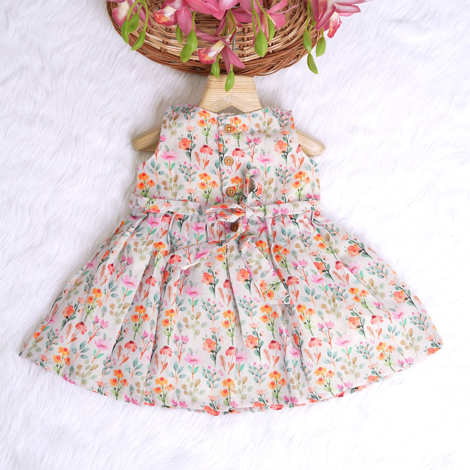 Baby girl in a white sleeveless floral frock made of slub cotton, designed for 6 months to 5 years – part of the Boon Babies kidswear collection in Coimbatore.