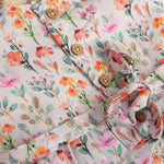 Baby girl in a white sleeveless floral frock made of slub cotton, designed for 6 months to 5 years – part of the Boon Babies kidswear collection in Coimbatore.