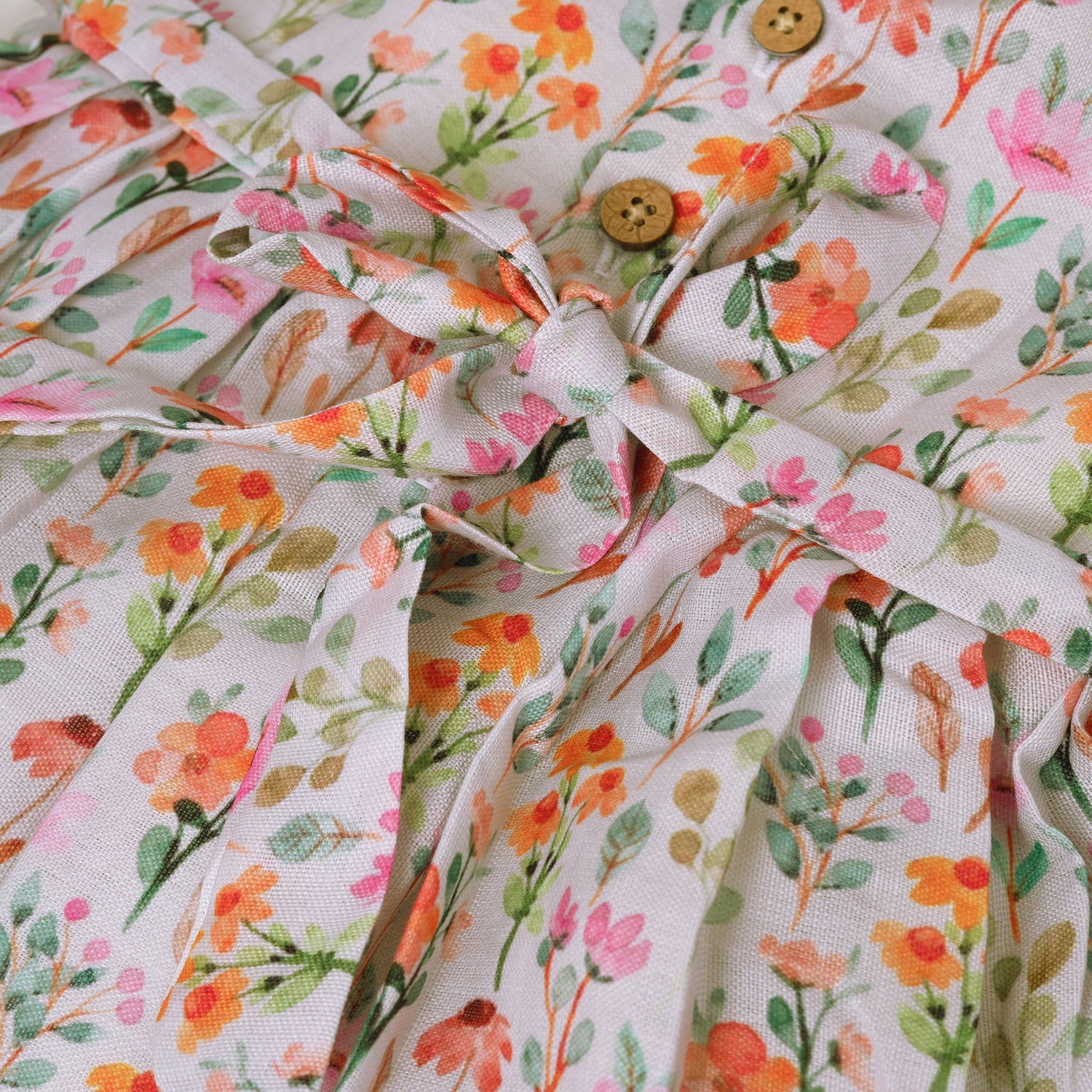 Baby girl in a white sleeveless floral frock made of slub cotton, designed for 6 months to 5 years – part of the Boon Babies kidswear collection in Coimbatore.