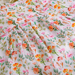 Baby girl in a white sleeveless floral frock made of slub cotton, designed for 6 months to 5 years – part of the Boon Babies kidswear collection in Coimbatore.