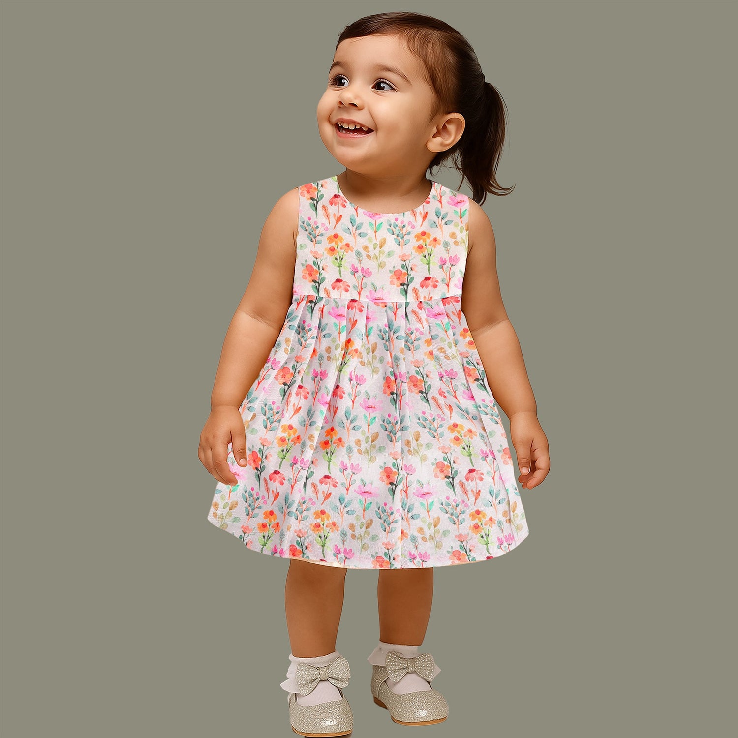 Baby girl in a white sleeveless floral frock made of slub cotton, designed for 6 months to 5 years – part of the Boon Babies kidswear collection in Coimbatore.