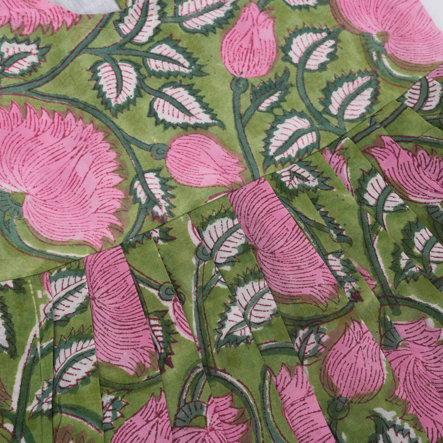 Soft cotton frock with cap sleeves and floral block print. Perfect comfort and style for girls aged 6M–5Y.
