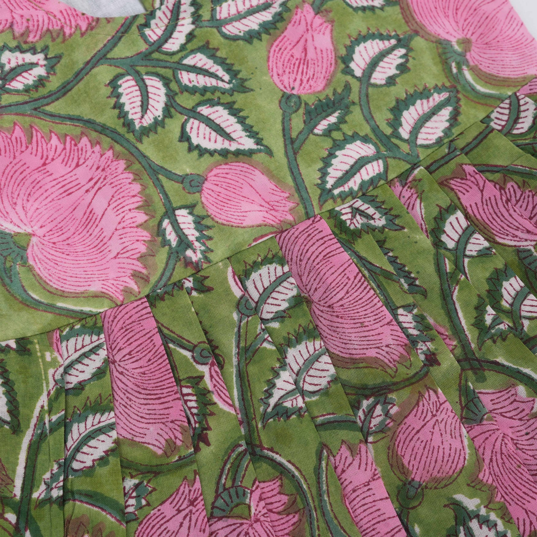 Soft cotton frock with cap sleeves and floral block print. Perfect comfort and style for girls aged 6M–5Y.
