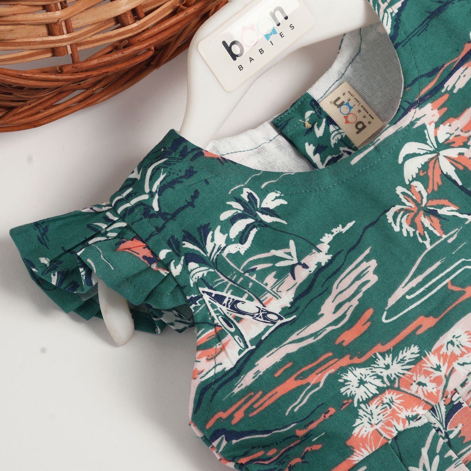Green cotton frock with tropical island print and cap sleeves for baby girls aged 6 months to 5 years – Boon Babies kidswear collection from Coimbatore.
