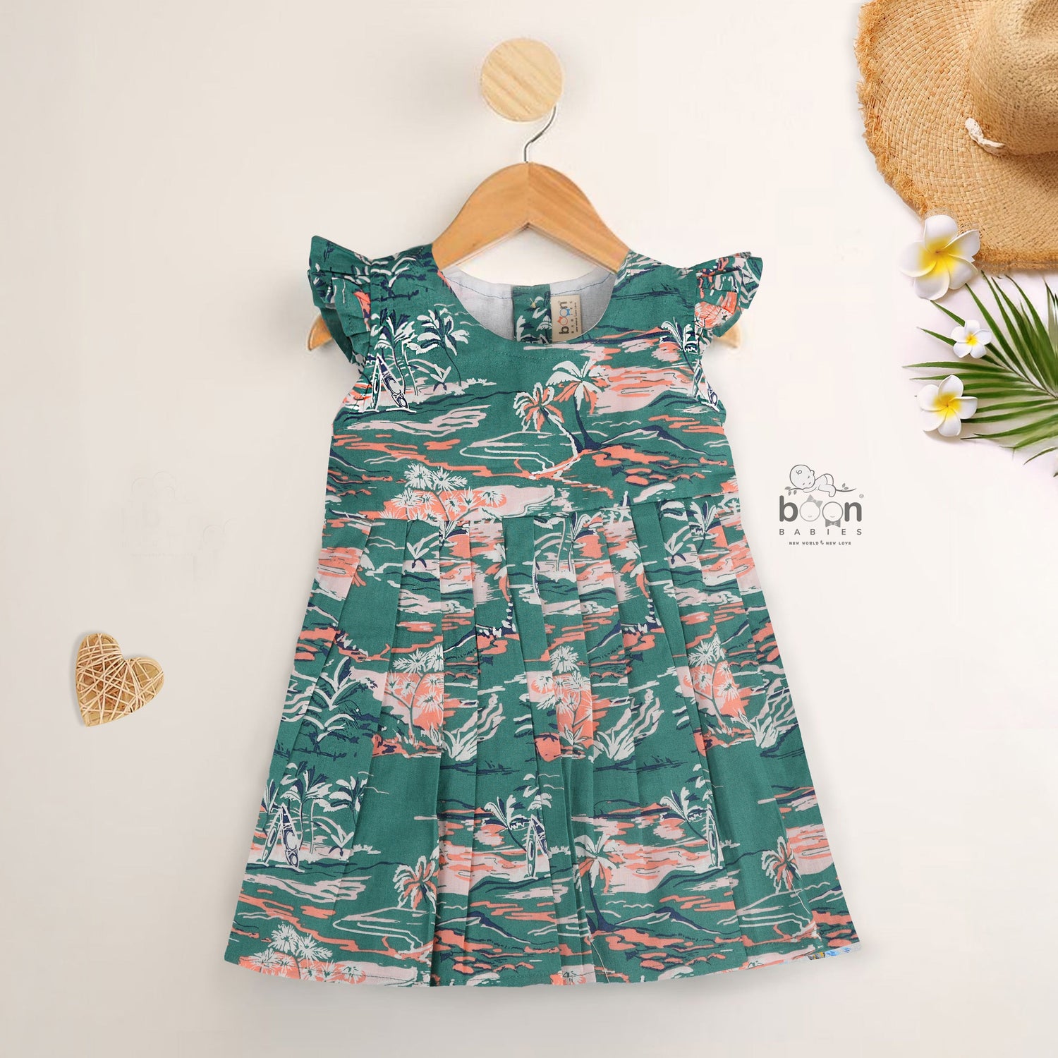 Green cotton frock with tropical island print and cap sleeves for baby girls aged 6 months to 5 years – Boon Babies kidswear collection from Coimbatore.
