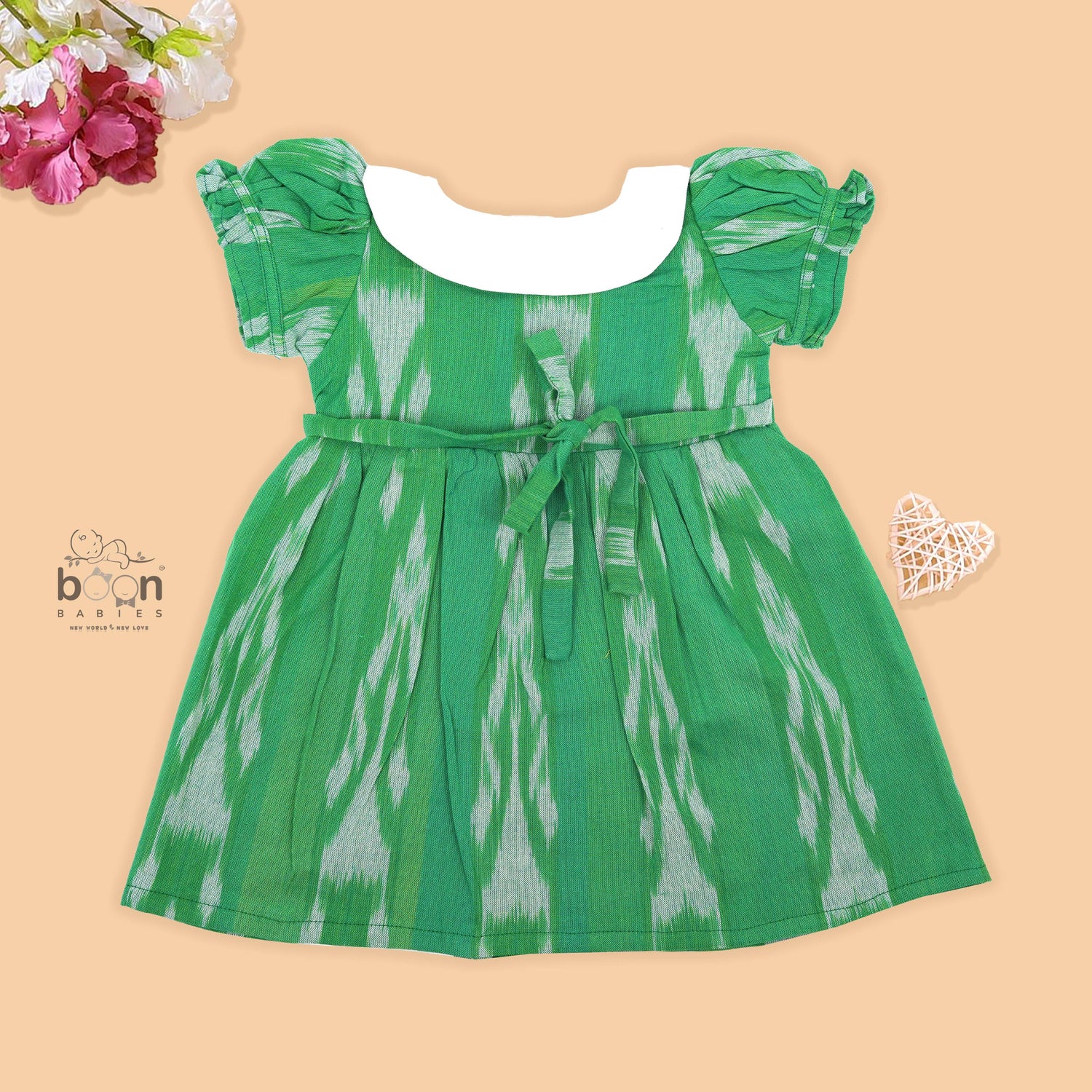 Green ikat print cotton puff frock with white collar & bow. Ages 6M–4Y. Soft, breathable & stylish festive wear for baby girls.
