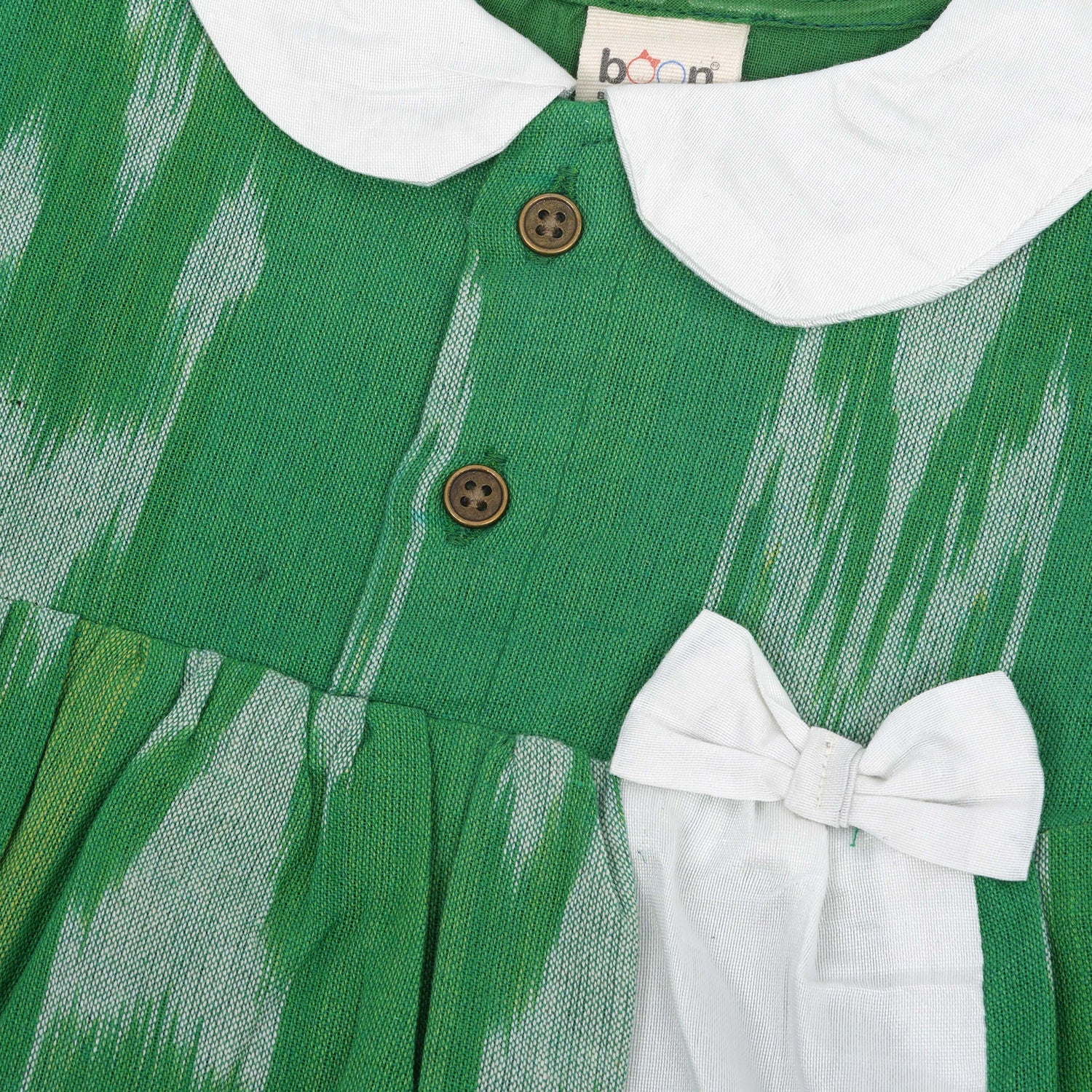 Green ikat print cotton puff frock with white collar & bow. Ages 6M–4Y. Soft, breathable & stylish festive wear for baby girls.