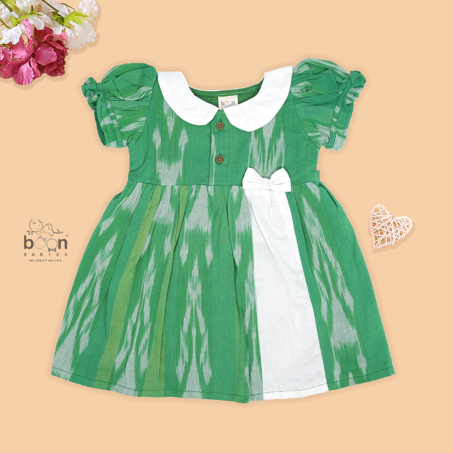 Green ikat print cotton puff frock with white collar & bow. Ages 6M–4Y. Soft, breathable & stylish festive wear for baby girls.