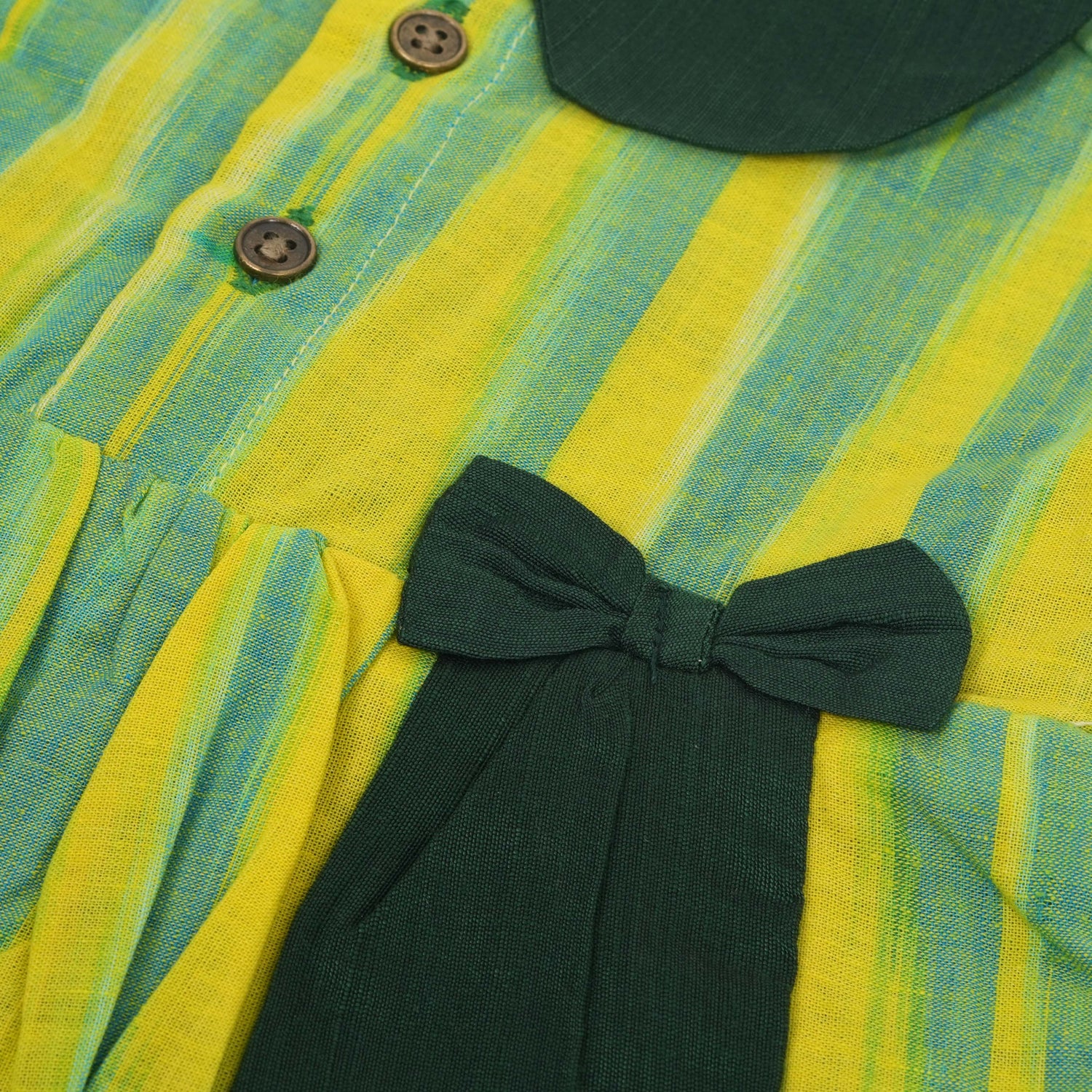 Green & Yellow cotton ikat puff frock with contrast collar & bow. Sizes 6M–4Y. Comfy, ethnic-inspired & festive-ready.