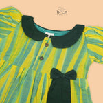 Green & Yellow cotton ikat puff frock with contrast collar & bow. Sizes 6M–4Y. Comfy, ethnic-inspired & festive-ready.