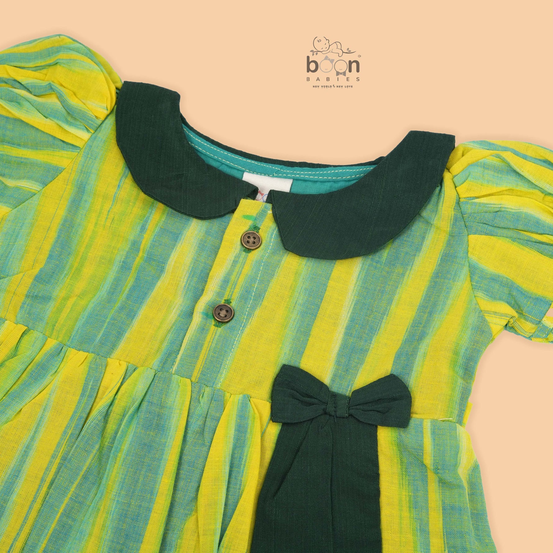 Green & Yellow cotton ikat puff frock with contrast collar & bow. Sizes 6M–4Y. Comfy, ethnic-inspired & festive-ready.