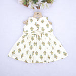 Toddler girl wearing an ivory sleeveless cotton frock with traditional floral butta print – ethnic babywear from Boon Babies, Coimbatore.